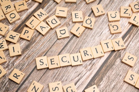 A bunch of scrambled wooden blocks with letters arranged to spell the word ‘Security.’